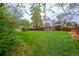 Spacious backyard with mature trees, green grass, wooden fence, and shed at 3200 W Chenango Ave, Englewood, CO 80110