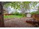 Backyard featuring lush green grass, wooden fence, mature trees, and storage shed at 3200 W Chenango Ave, Englewood, CO 80110