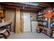 Unfinished basement with open ceiling, concrete walls, shelving and storage space at 3200 W Chenango Ave, Englewood, CO 80110