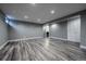 Spacious finished basement with wood-look flooring and recessed lighting throughout at 3200 W Chenango Ave, Englewood, CO 80110