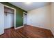 Bedroom featuring hardwood floors, closet with an open door and adjoining room at 3200 W Chenango Ave, Englewood, CO 80110