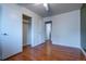 Bedroom with hardwood floors, a ceiling fan and bright white closet doors at 3200 W Chenango Ave, Englewood, CO 80110