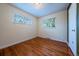 Bright bedroom featuring hardwood floors and natural light from two windows with blinds at 3200 W Chenango Ave, Englewood, CO 80110