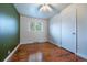 Bedroom with hardwood floors, a ceiling fan and bright white trim at 3200 W Chenango Ave, Englewood, CO 80110