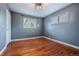 Cozy bedroom with hardwood floors, two windows with tree views and neutral gray walls at 3200 W Chenango Ave, Englewood, CO 80110