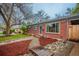 Cozy brick home with a well-manicured lawn, stone accents, and inviting entryway at 3200 W Chenango Ave, Englewood, CO 80110