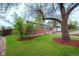 Charming brick home with well-maintained lawn, mature tree, and manicured landscaping at 3200 W Chenango Ave, Englewood, CO 80110