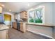 Bright kitchen featuring stainless steel appliances, wood cabinets, granite countertop, and a breakfast bar at 3200 W Chenango Ave, Englewood, CO 80110