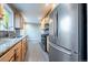 Well-equipped kitchen with stainless steel appliances and light wood cabinetry at 3200 W Chenango Ave, Englewood, CO 80110