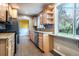 Updated kitchen with stainless steel appliances, tile backsplash, and granite countertops at 3200 W Chenango Ave, Englewood, CO 80110