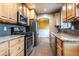 Modern kitchen with stainless steel appliances, granite counters, and plenty of cabinet space at 3200 W Chenango Ave, Englewood, CO 80110