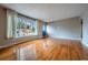 Inviting living room with shiny hardwood floors, a large window, and neutral wall color at 3200 W Chenango Ave, Englewood, CO 80110