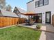 Spacious backyard with a well-maintained lawn and an outdoor dining set, perfect for summer gatherings at 4525 N Raleigh St, Denver, CO 80212