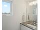 Clean, bright bathroom with gray countertops, modern fixtures, and a window at 4525 N Raleigh St, Denver, CO 80212