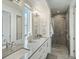 Bright bathroom featuring double vanity, modern finishes, and a sleek glass-enclosed shower at 4525 N Raleigh St, Denver, CO 80212
