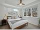 Bright primary bedroom featuring tray ceiling, large windows, and neutral decor at 4525 N Raleigh St, Denver, CO 80212