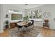 The dining room features a large window, a modern light fixture, and a stylish area rug at 4525 N Raleigh St, Denver, CO 80212