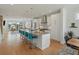 Bright open kitchen features modern appliances, an island with seating, and a seamless flow to the living areas at 4525 N Raleigh St, Denver, CO 80212