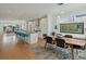Open concept kitchen and dining area boasts a spacious island, stainless steel appliances, and modern finishes at 4525 N Raleigh St, Denver, CO 80212