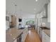 Spacious kitchen with stainless appliances, a large island, and an open layout that flows into the living area at 4525 N Raleigh St, Denver, CO 80212