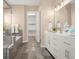 Bathroom featuring tiled tub/shower, walk-in closet, and double sink vanity with countertop at 3309 Thornwood Ct, Castle Rock, CO 80108