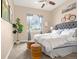 Relaxing bedroom with soft carpet, large window, gray headboard, and decorative bicycle at 3309 Thornwood Ct, Castle Rock, CO 80108
