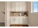 Butler pantry with white cabinets and granite counters at 3309 Thornwood Ct, Castle Rock, CO 80108