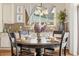 Close up of a dining table, with full place settings, beneath a chandelier with a view out the window at 3309 Thornwood Ct, Castle Rock, CO 80108