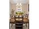 Set dining room table with seating for eight beneath a decorative chandelier at 3309 Thornwood Ct, Castle Rock, CO 80108