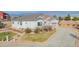 Lovely exterior view with a curved driveway, a two-car garage, and manicured landscaping at 3309 Thornwood Ct, Castle Rock, CO 80108