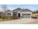 Charming single-Gathering home features stone accents, a two-car garage, and a well-manicured front yard at 3309 Thornwood Ct, Castle Rock, CO 80108