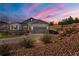 Beautiful home exterior at sunset with a well-maintained yard, rock landscaping, and inviting curb appeal at 3309 Thornwood Ct, Castle Rock, CO 80108
