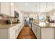 Gourmet kitchen featuring stainless appliances, granite counters, tile backsplash, and a large kitchen island at 3309 Thornwood Ct, Castle Rock, CO 80108