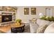 Inviting living room features a stone fireplace, hardwood floors, and a comfortable seating area at 3309 Thornwood Ct, Castle Rock, CO 80108
