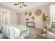 Bright main bedroom featuring tray ceiling, cozy seating area, and stylish wall decor at 3309 Thornwood Ct, Castle Rock, CO 80108
