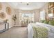 Bright main bedroom featuring tray ceiling, bay window, seating area, and unique bamboo bed frame at 3309 Thornwood Ct, Castle Rock, CO 80108