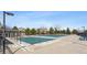 Large pool area covered for the off-season with lounge seating and lush landscaping surrounding it at 3309 Thornwood Ct, Castle Rock, CO 80108