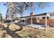 Backyard featuring a covered patio area off of a brick home with mature trees at 6851 S Franklin St, Centennial, CO 80122