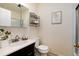 Neutral bathroom with a glass-enclosed shower, dark vanity, and modern fixtures at 6851 S Franklin St, Centennial, CO 80122