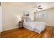 Serene bedroom features hardwood floors, ceiling fan, neutral walls, and natural light from shuttered windows at 6851 S Franklin St, Centennial, CO 80122