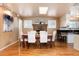 Charming dining room featuring hardwood floors, a brick fireplace, and white shuttered windows at 6851 S Franklin St, Centennial, CO 80122