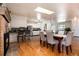 Open-concept dining room features a skylight and transitions into the kitchen with a breakfast bar and fireplace at 6851 S Franklin St, Centennial, CO 80122