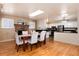 Well-lit dining room with fireplace flows into a modern kitchen, ideal for gatherings at 6851 S Franklin St, Centennial, CO 80122