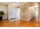 Inviting entryway with hardwood floors, white paneled door and neutral decor offers a warm welcome at 6851 S Franklin St, Centennial, CO 80122