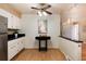 Cozy kitchen area with white cabinets, black granite countertops, and a table for casual dining at 6851 S Franklin St, Centennial, CO 80122