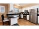 Bright kitchen boasts stainless steel appliances, white cabinets, granite countertops, and breakfast bar seating at 6851 S Franklin St, Centennial, CO 80122