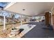 Backyard covered patio with ceiling lighting overlooking the mature landscaped yard and wooden privacy fence at 6851 S Franklin St, Centennial, CO 80122