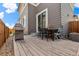Wooden back deck with chairs and grill, ideal for outdoor entertaining at 11235 S Neu Towne Cir, Parker, CO 80134