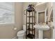 Cozy half-bathroom with pedestal sink and decorative shelving at 11235 S Neu Towne Cir, Parker, CO 80134