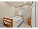 Bedroom with a wooden bed frame, neutral walls, and natural light from the window at 11235 S Neu Towne Cir, Parker, CO 80134